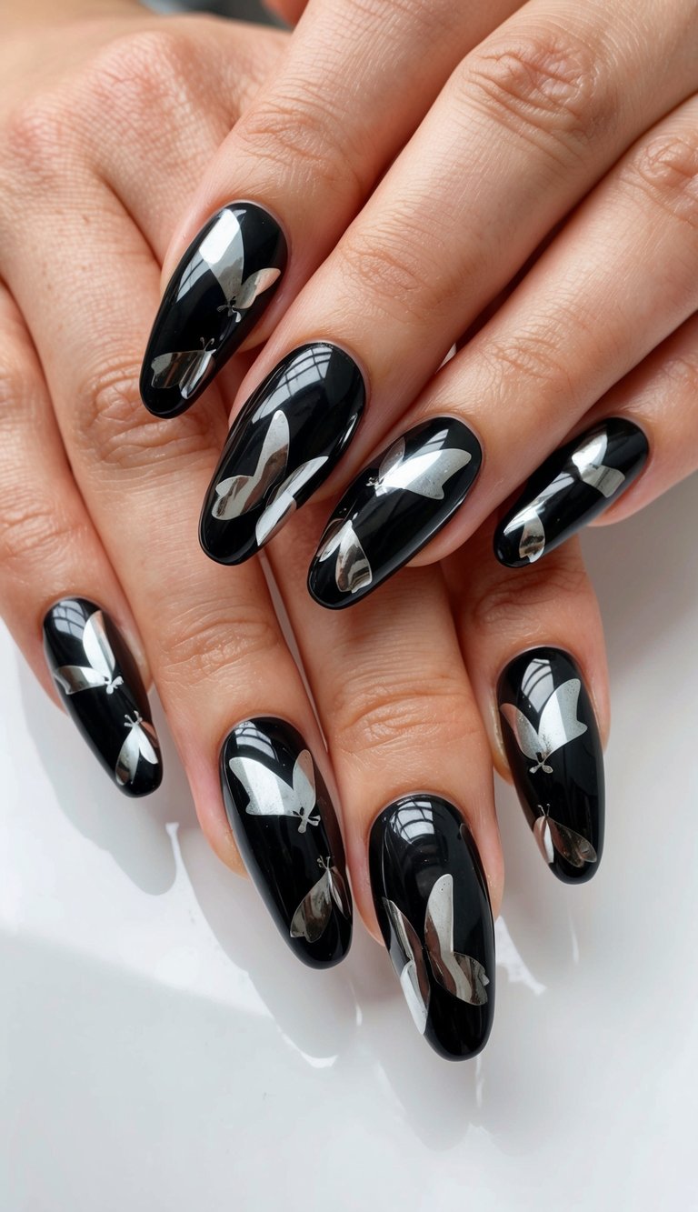 A close-up of black chrome butterflies on a glossy nail surface