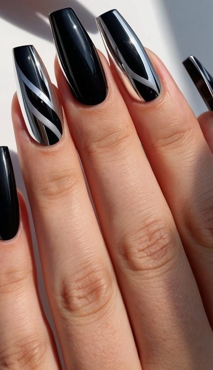 Black and chrome manicure featuring reflective swirl accents over glossy black polish for a futuristic, polished look.