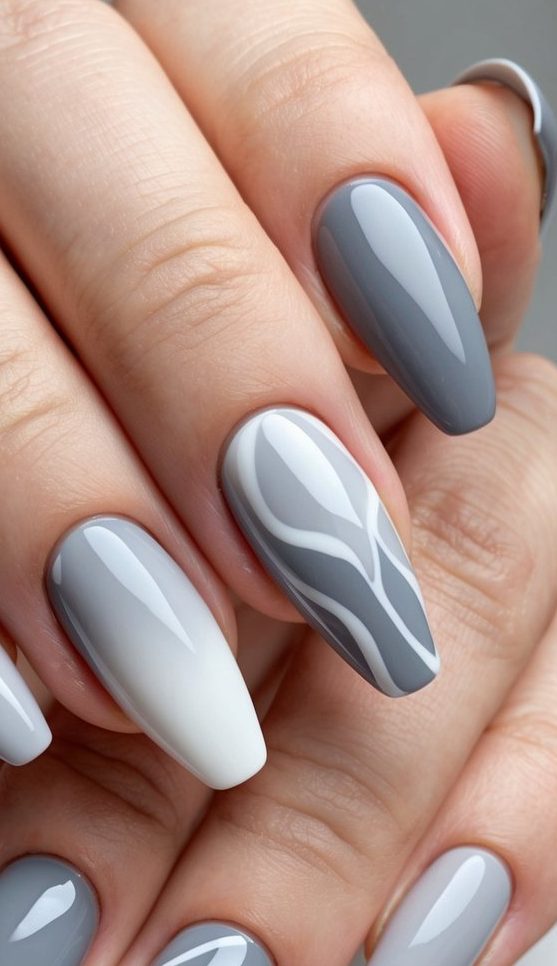 A close-up of elegant gray ombre nail art designs with smooth transitions and abstract patterns