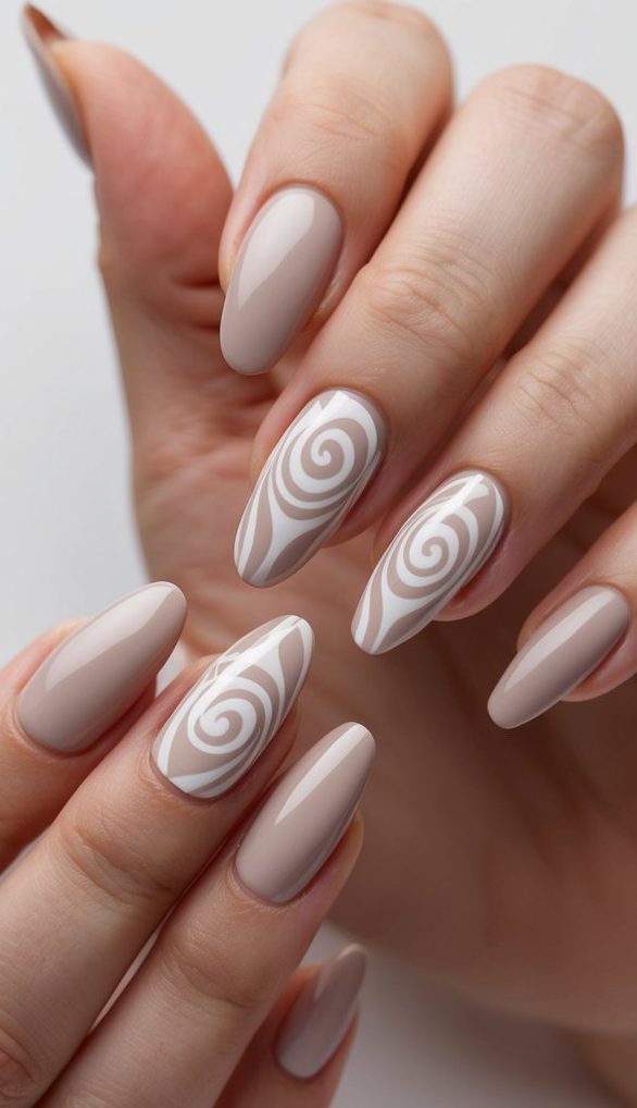 A delicate latte swirl design adorns a set of neutral nails, creating a timeless and elegant look