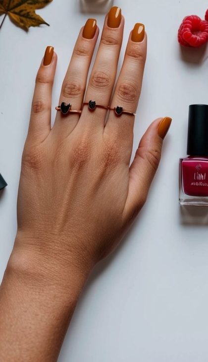 A hand with caramel-brown nails in a clean square shape, ideal for a bold yet simple September nail idea.
