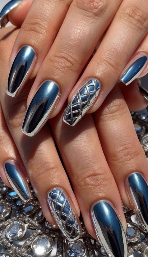 Hand displaying metallic coffin nails with detailed silver geometric accent nails placed over circular rhinestone-covered decorative surface.
