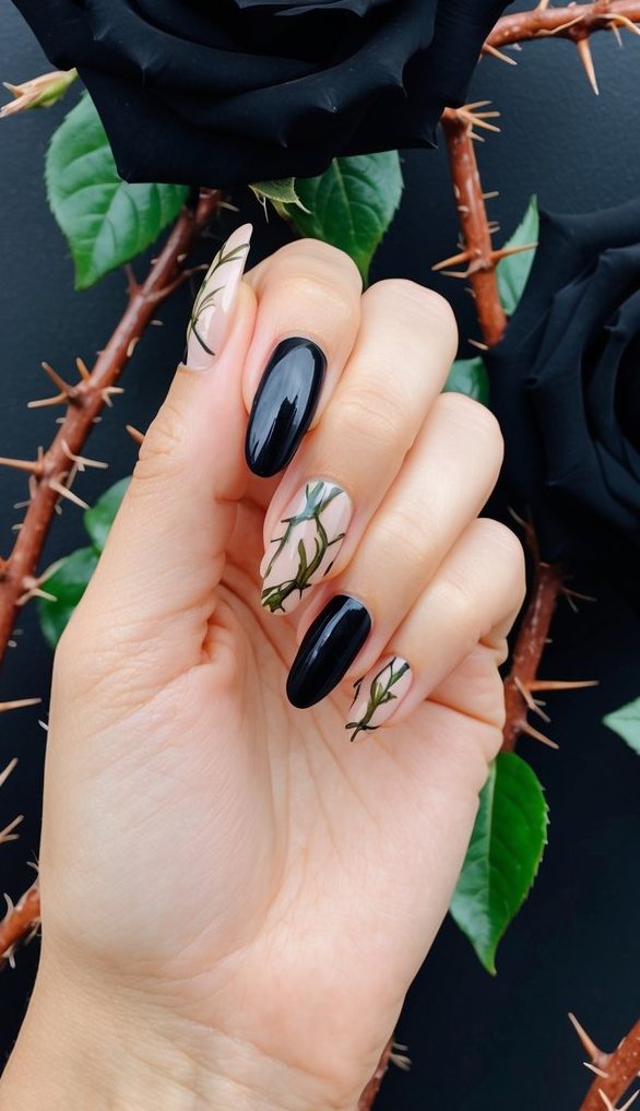 Glossy black nails with nude and green vine details, creating a moody and botanical emo-inspired manicure.
