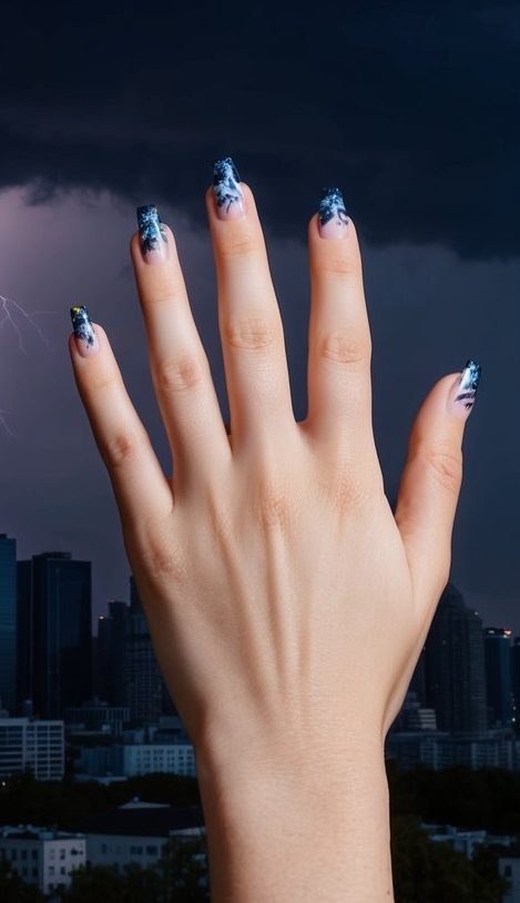 Translucent nails with moody blue marble effects that mimic a stormy sky and lightning, perfect for dark emo aesthetics.