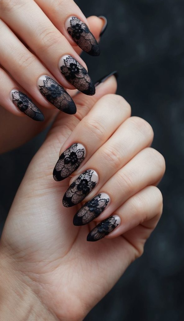 Floral lace and mesh black designs over nude nails, creating a soft yet dramatic emo-inspired manicure.