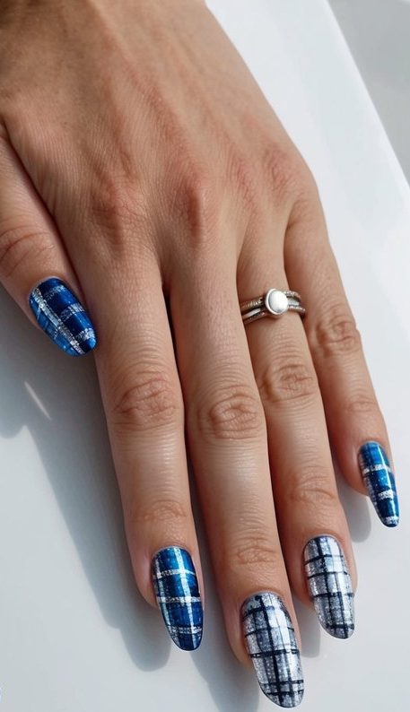 Plaid nails in cobalt blue and silver tones, echoing the cozy texture of winter flannel in a trendy January design.