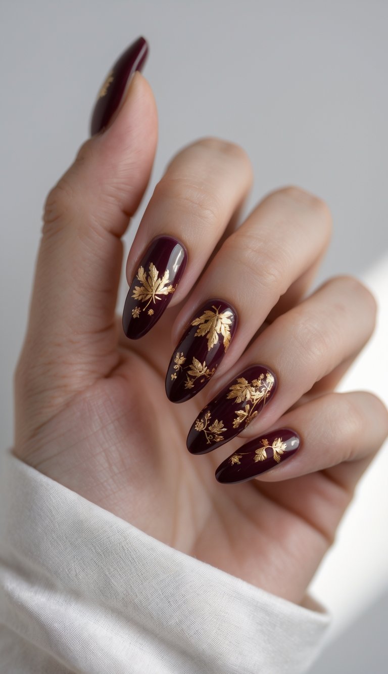 These deep burgundy nails shine with metallic gold leaf details for a look that’s totally luxe. 
