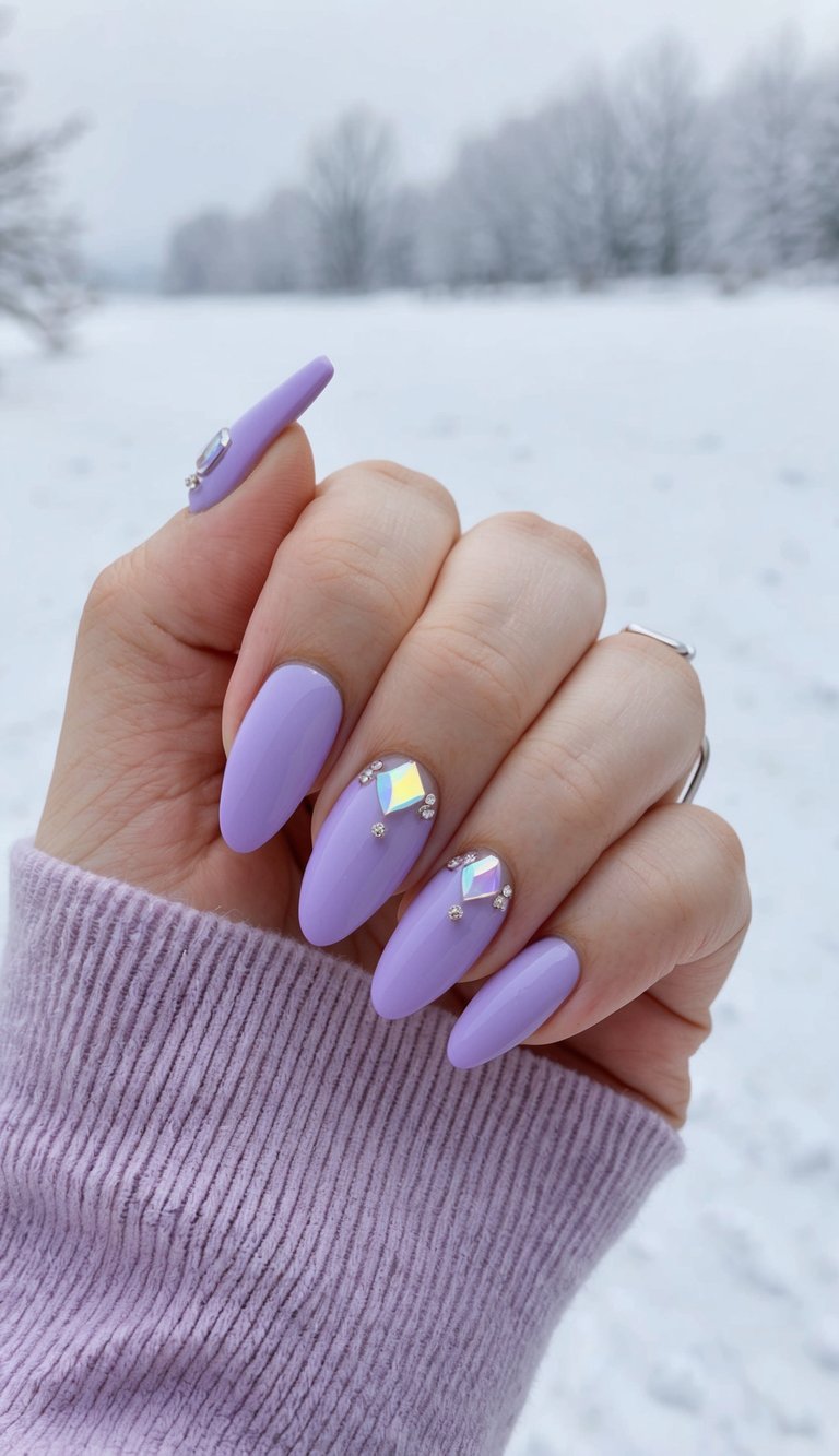 A close-up of lavender-tipped nails with crystal-like accents, set against a soft winter background