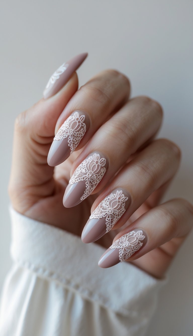 Elegant dusty rose nail art idea featuring long, almond-shaped nails painted in a muted mauve, each decorated with finely placed lace motifs that evoke vintage bridal charm.
