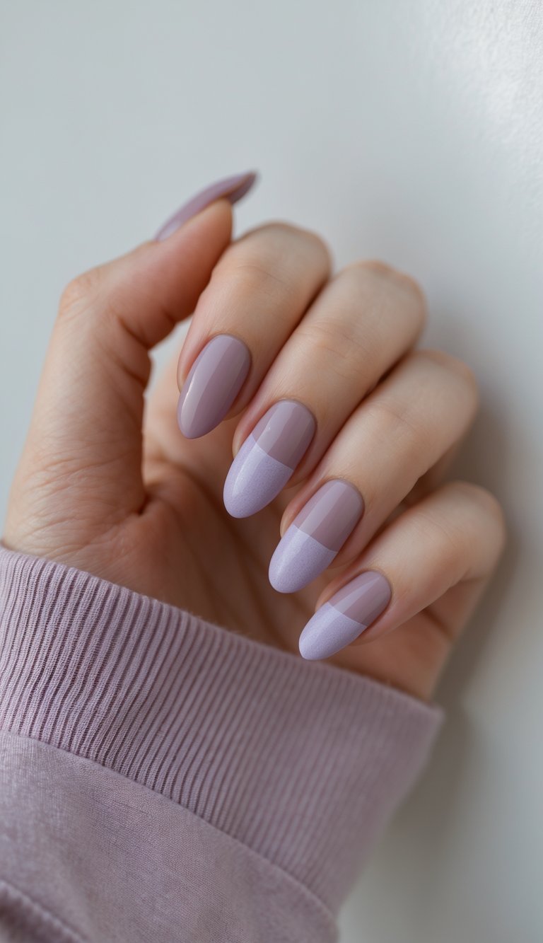 Close-up of a dusty rose nail art idea showing long almond nails painted with a glossy mauve base and finished with matte lavender tips in a clean, modern color block design.