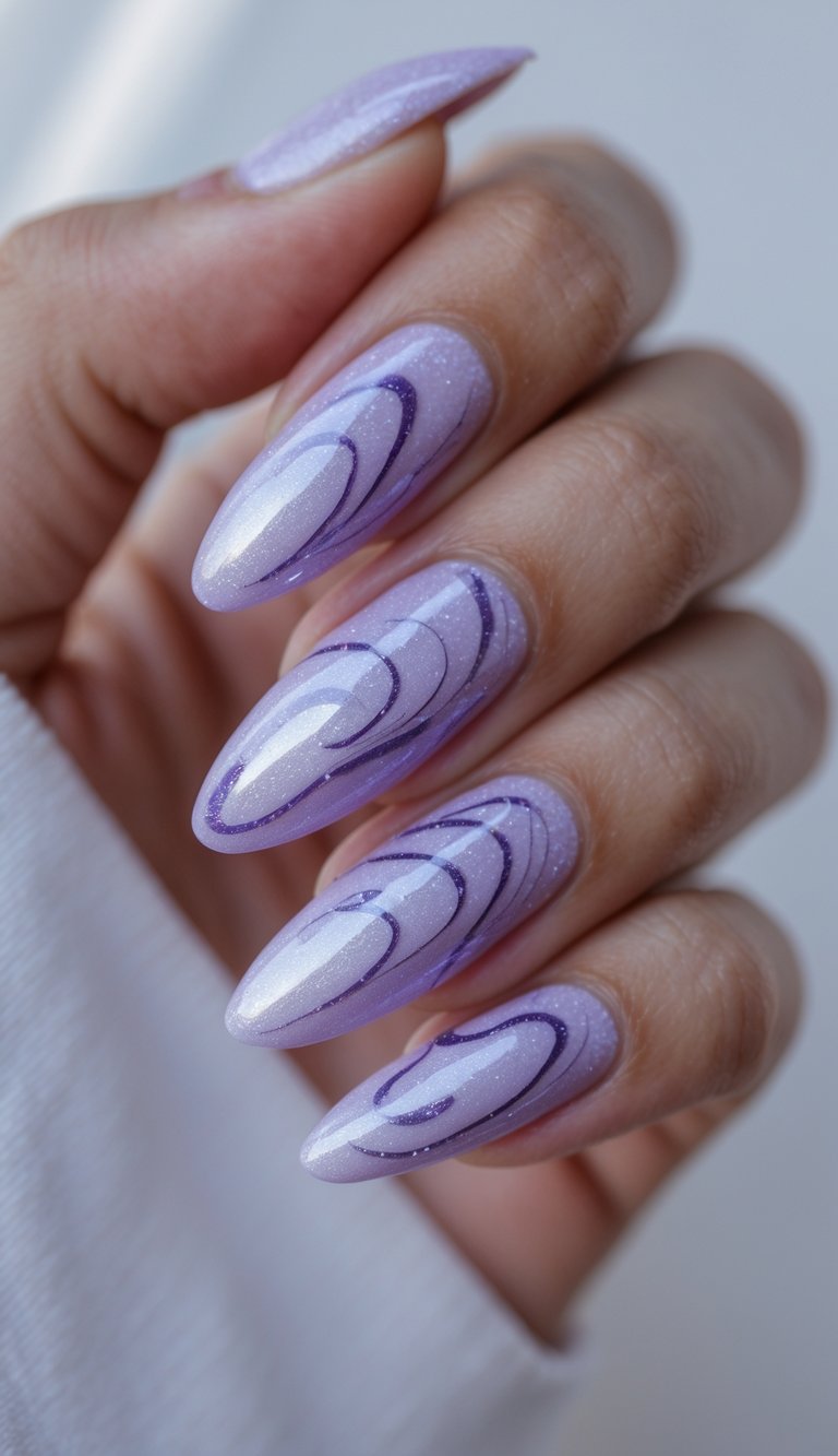 Close-up of a hand with almond-shaped nails painted in a soft shimmer base and decorated with lavender swirls, showcasing a graceful shimmery nail art idea.