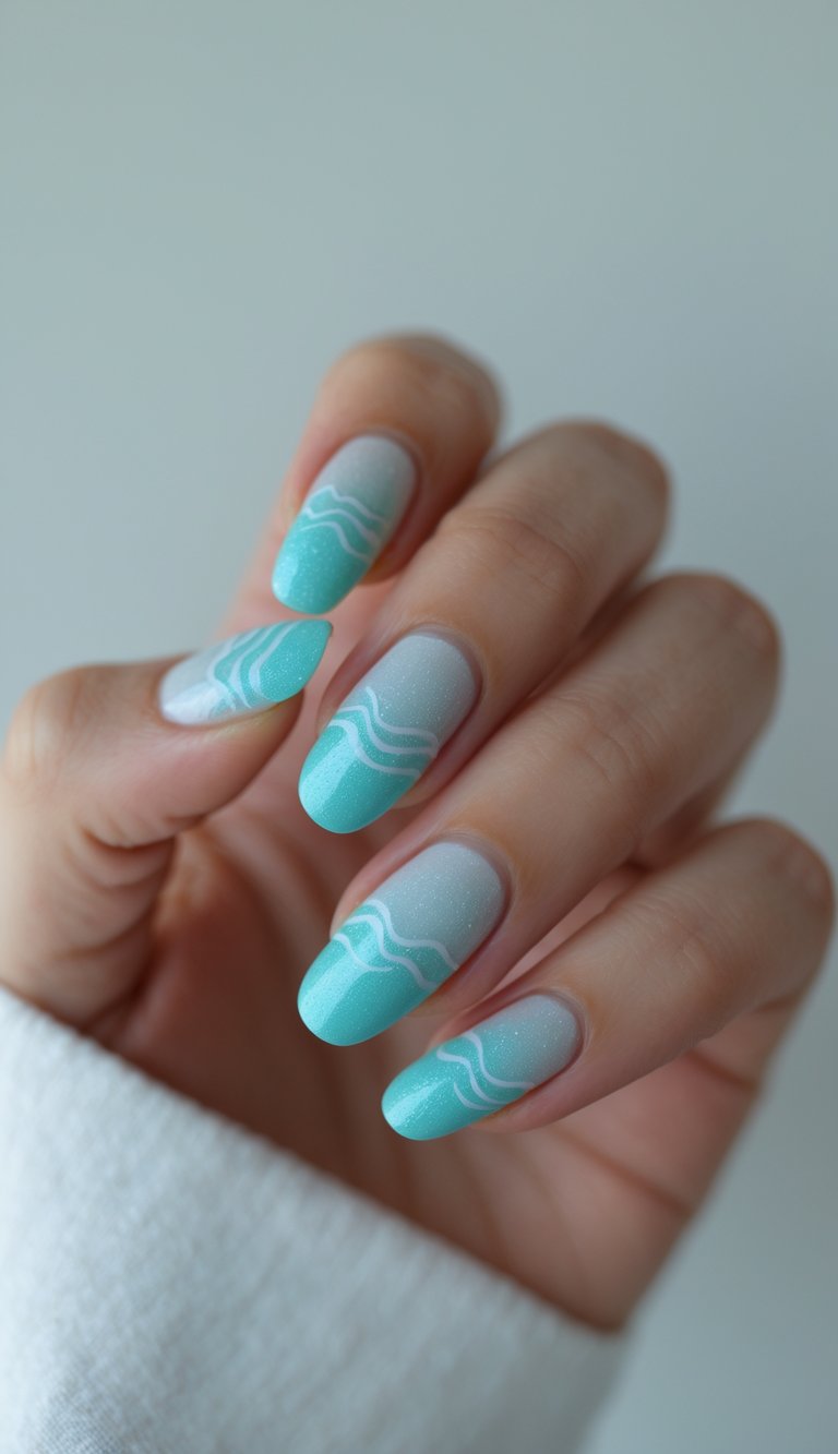 Shimmery nail art idea featuring teal-to-white ombré with soft wave lines, resembling sunlight dancing on ocean waves.