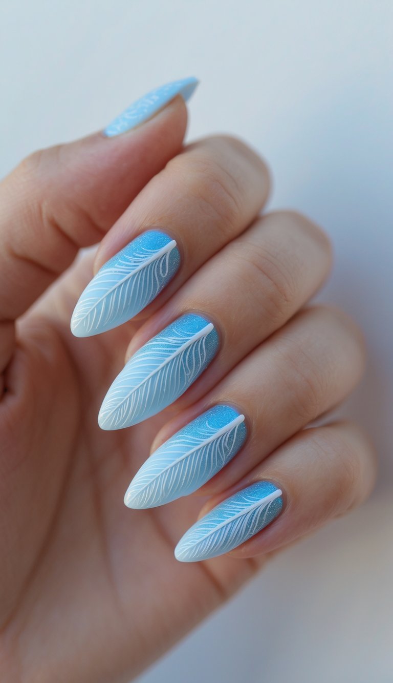 Shimmery nail art idea with icy blue ombré nails and intricate white feather-like designs, evoking a frosty, ethereal finish.