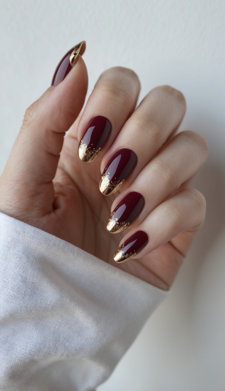 A softly clenched hand showing glossy red nails decorated with scattered gold foil at the tips—perfectly festive and fierce glossy nail art idea.