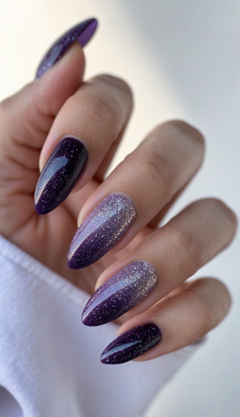 Close-up of a hand featuring deep violet ombré nails dusted with glitter, capturing a bold and glamorous glossy nail art idea.