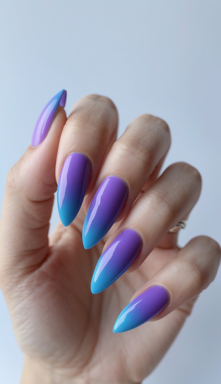 Almond-shaped nails with a high-gloss violet and sapphire ombré fade—an elegant, color-rich long nail art idea.