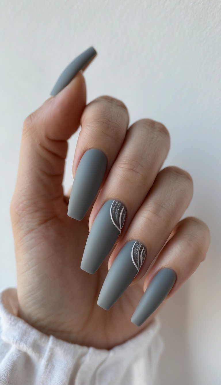 Coffin-shaped matte gray nails with soft metallic curve designs—a refined and quiet long nail art idea.
