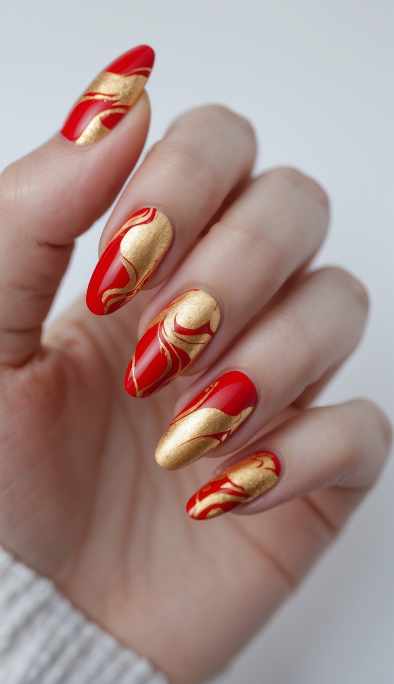 Hand with almond-shaped nails in glossy red and metallic gold swirl designs, showcasing a fiery and festive Chinese New Year nail art idea.