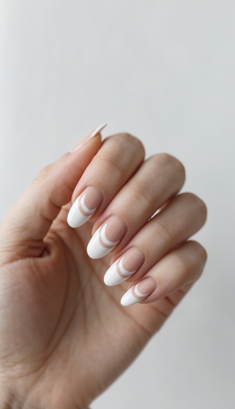 A hand displays almond nails with sheer nude polish and double white crescent stripes near the tips for a clean, graphic nail art style.