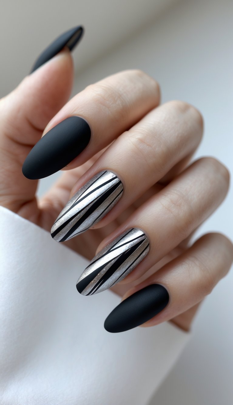 A polished hand featuring jet black matte nails and chrome accent designs with fine black striping—a confident and sharp sophisticated nail art idea for statement lovers.