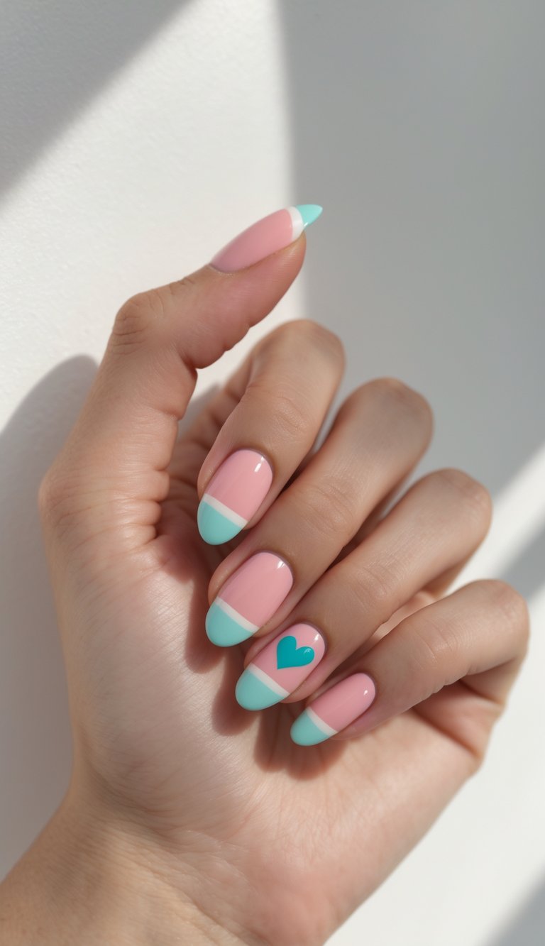 Close detail of pink nails paired with mint green French tips and a single heart accent, smooth glossy surface, and a playful colored French nail art idea look.