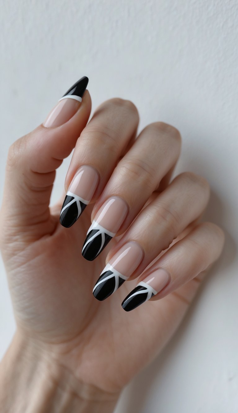Close-up of a single hand with black French tip nails decorated with white geometric designs on a white background.