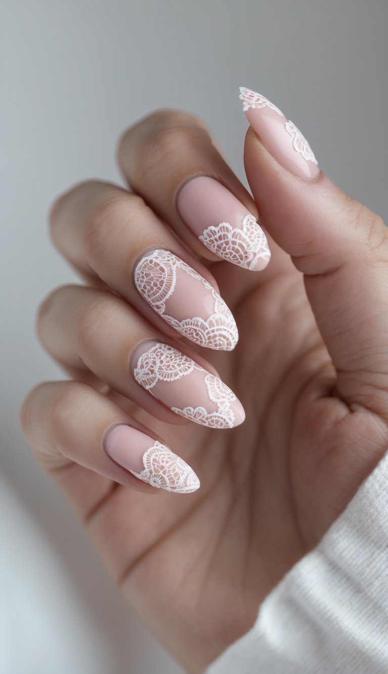 Close-up of a hand showing blush nail art idea with white lace designs that wrap around and across almond-shaped pink nails, resembling high-fashion textile patterns.
