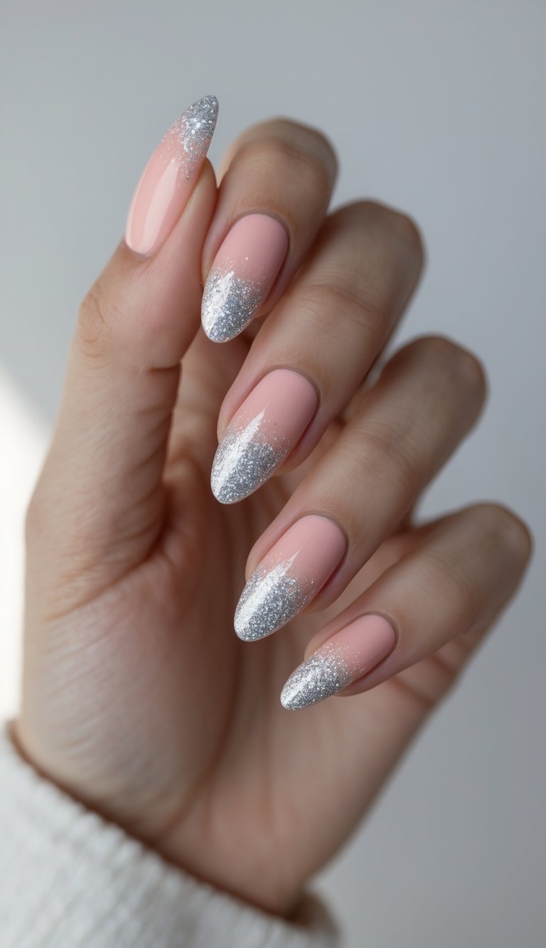 Blush nail art idea on almond nails, combining soft pink polish with layered silver glitter at the tips for a look that’s both celebratory and refined.