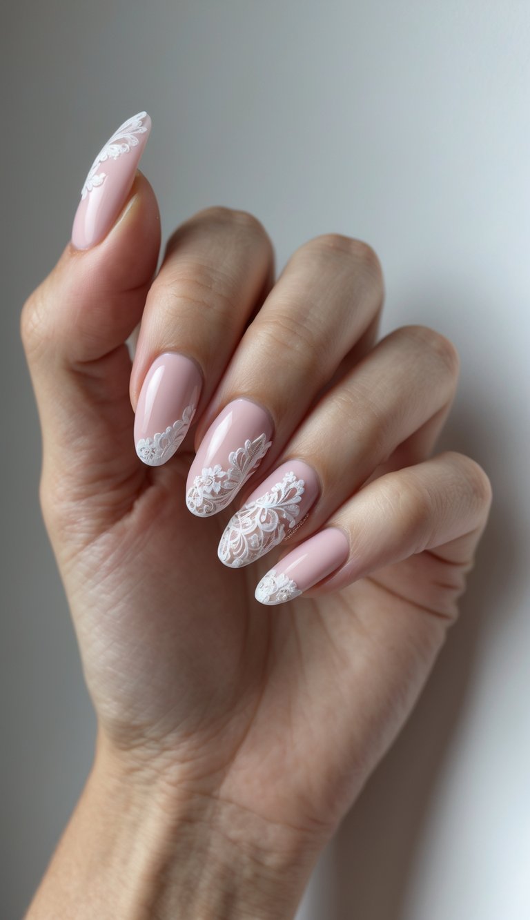 Seen from above, a manicured hand reveals a pink and silver nail art idea with glossy pink almond nails, detailed lace artwork, and subtle silver accents that add depth without overpowering.