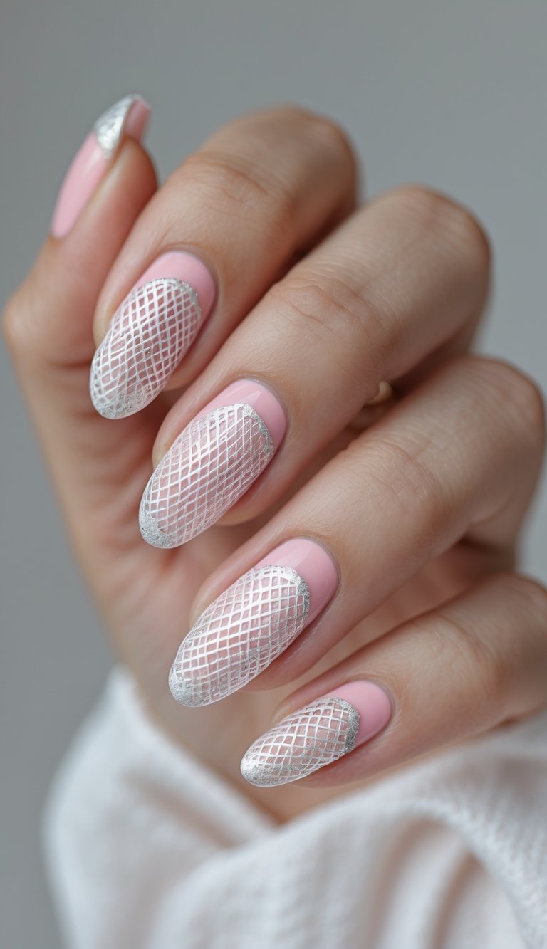 A close-up view shows a hand wearing a pink and silver nail art idea, highlighting blush-pink nails with fine white lattice patterns and silver-accented tips.