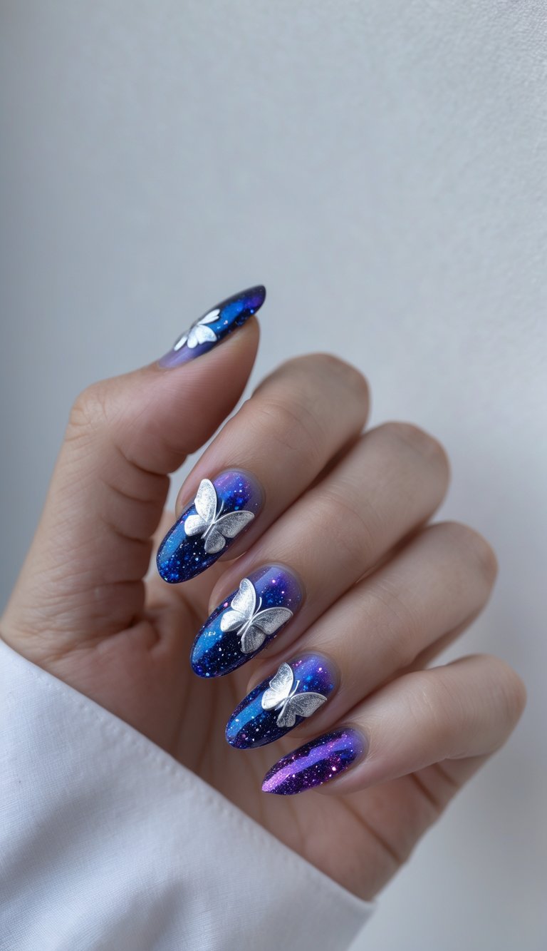 Close-up of galaxy nails in purple and blue with silver butterfly accents, showing a dreamy butterfly nail art idea inspired by the night sky.