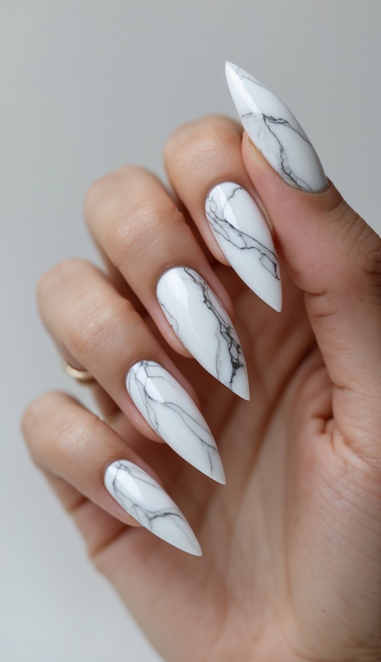 Stiletto nail art idea with icy white nails detailed in gray marble veining for a clean and modern twist