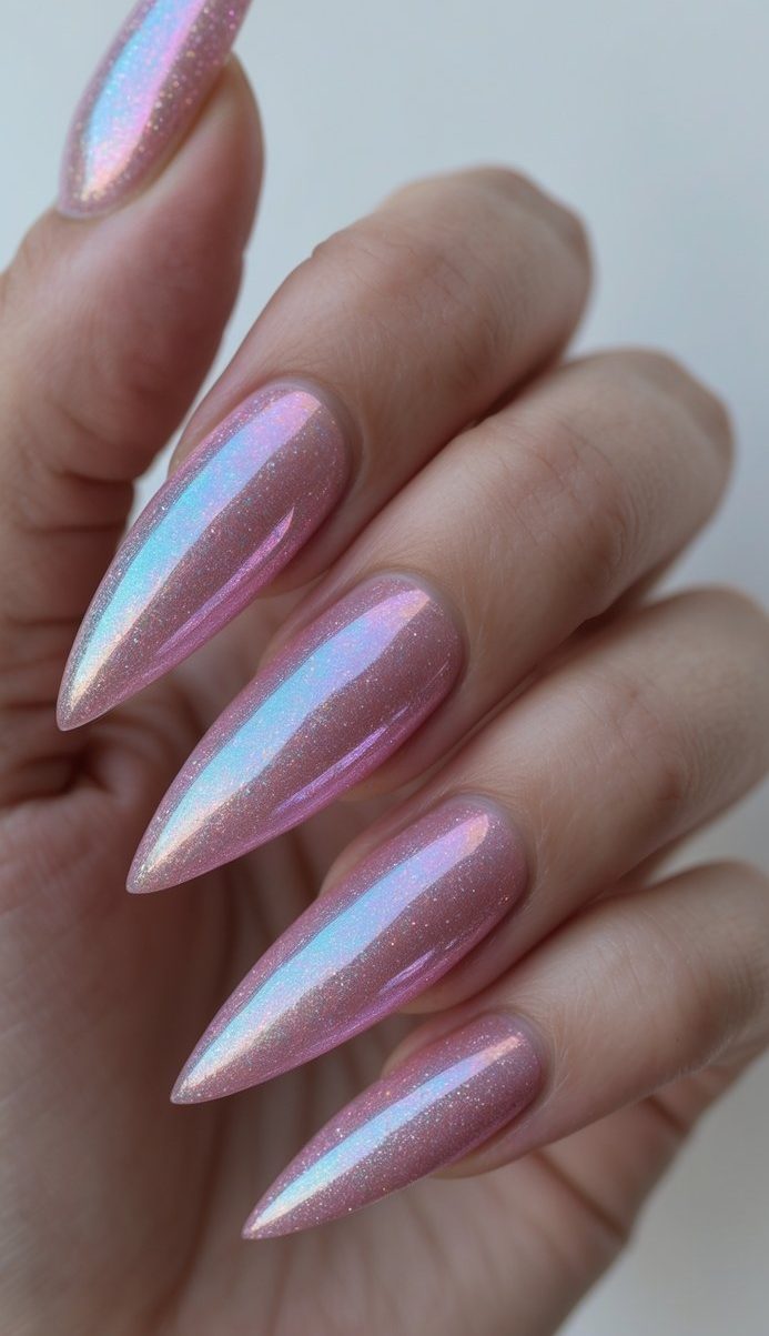 Stiletto nail art idea with glossy pink nails and blue fairy-like shimmer for a magical, sparkly finish