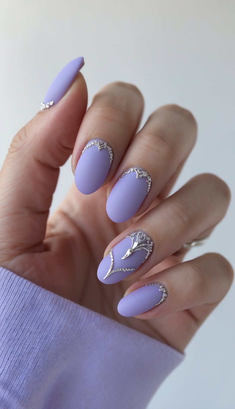 Close-up of a hand with round matte lavender nails enhanced by sleek silver 3D accents and curved metallic detailing, creating a stylish and luxurious nail look.