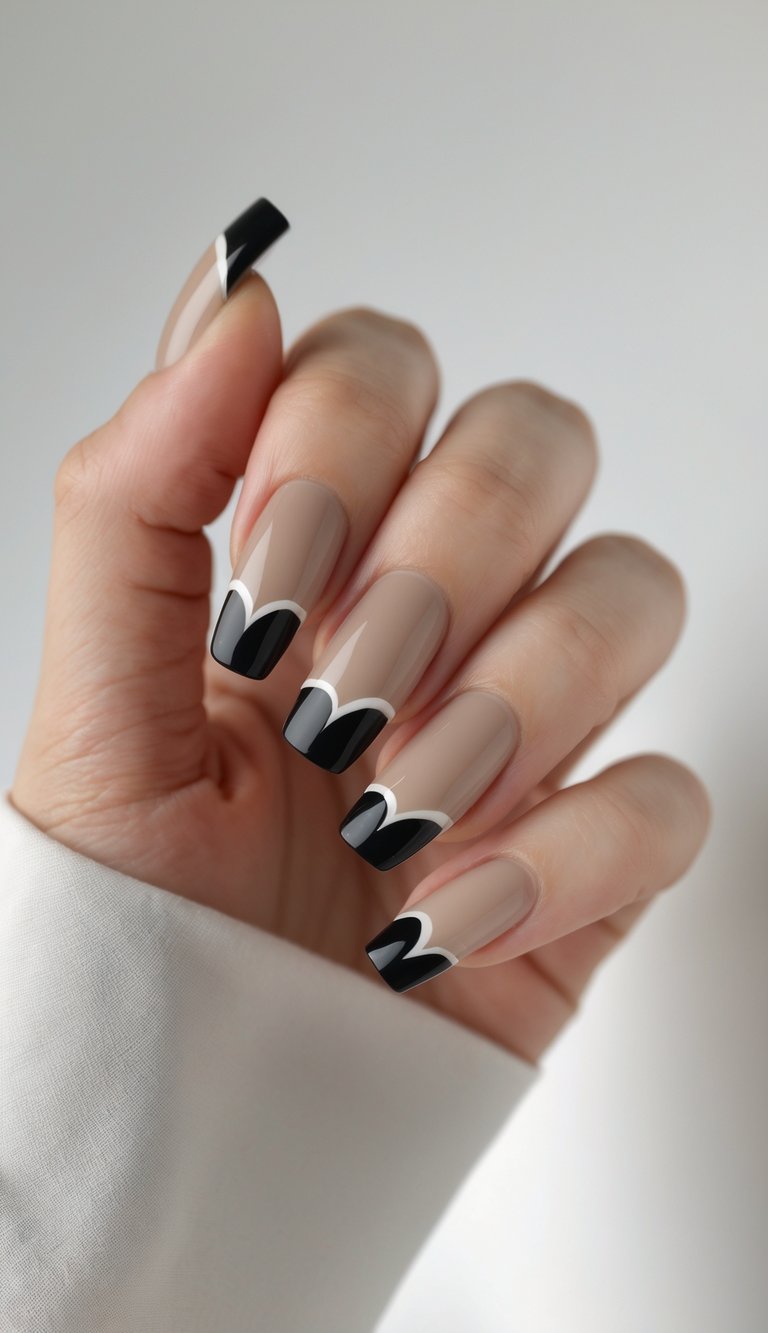 A hand displaying a square nail art idea with nude-toned nails and curved black French tips outlined in fine white, giving a high-fashion geometric effect.