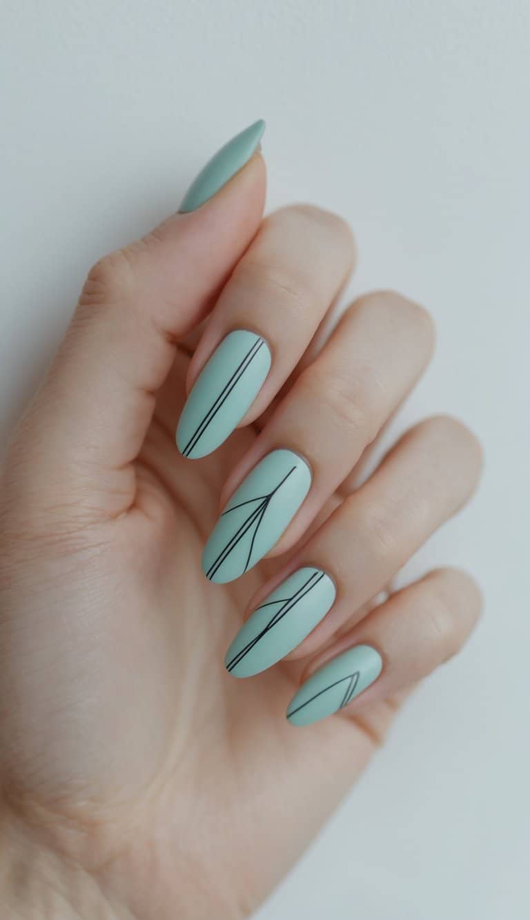 Close-up of hands with matte mint nails and thin black abstract line designs, presenting clean and modern march nail art ideas with minimal flair.