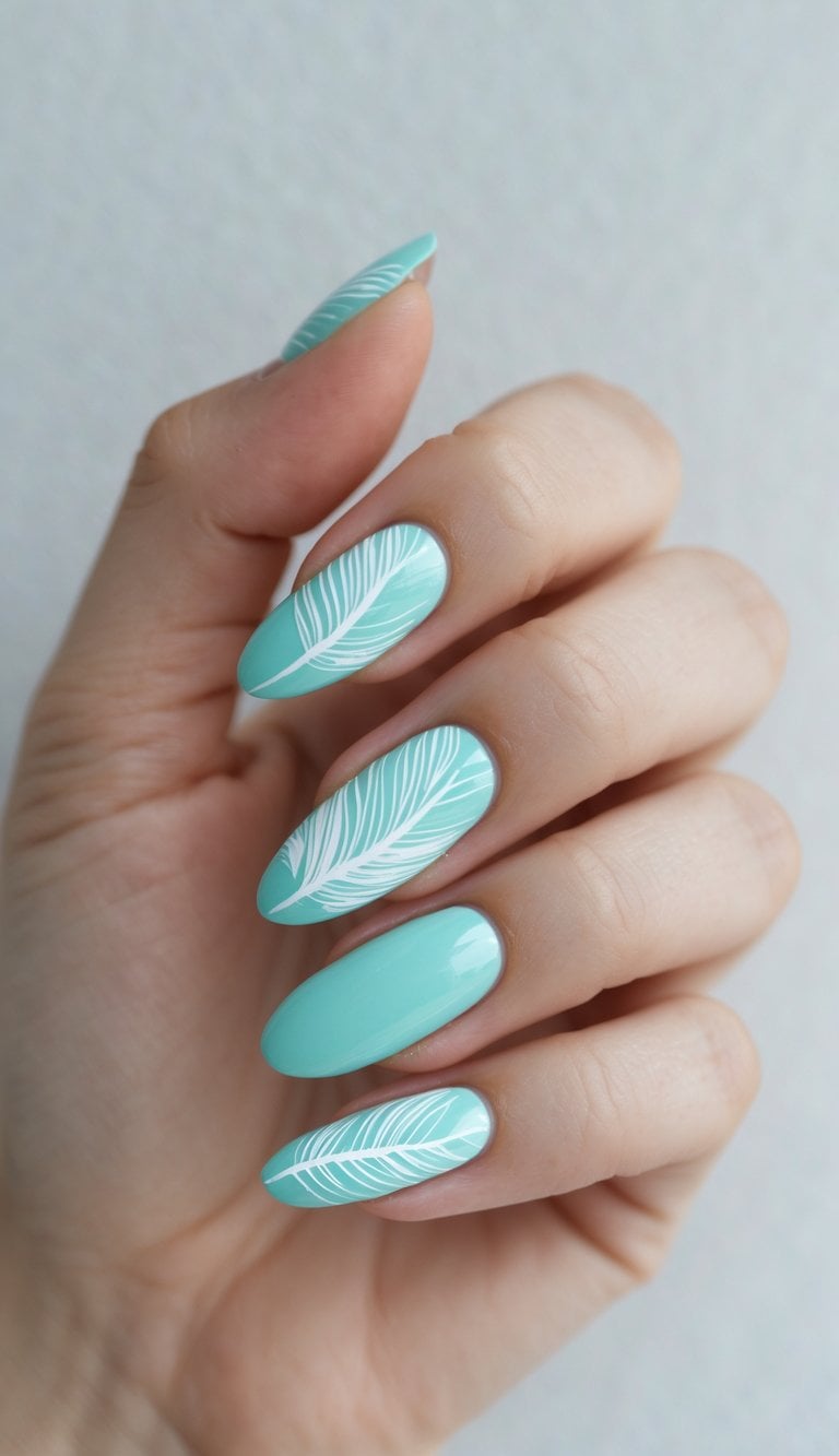 Close-up of hands with turquoise nails accented by crisp white feather patterns, presenting a modern take on march nail art ideas.