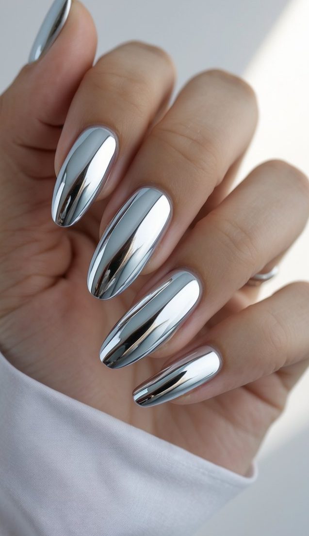 Highly reflective silver chrome nails showing a Viral nail art idea with smooth metallic polish, mirror-like shine, elongated shape, and a clean, modern finish.