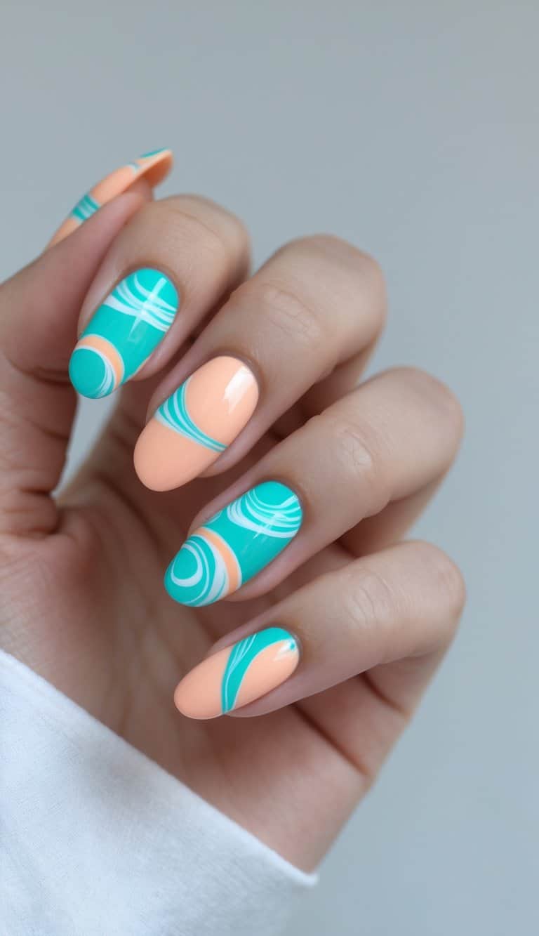 Natural light highlights a hand displaying peach and teal nails, some detailed with curved teal striping that adds movement to the two-tone manicure.