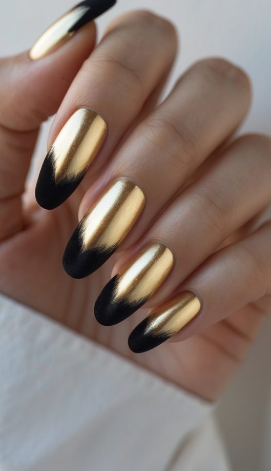 Glossy nail art idea that blends glamorous gold chrome polish with soft matte black tips for a sophisticated, high-impact nail design.