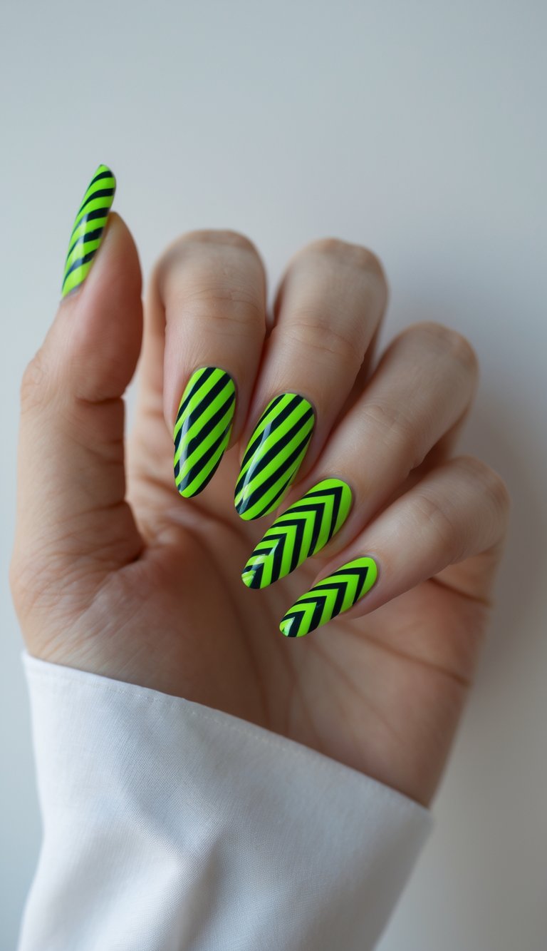 A hand with long almond nails featuring geometric nail art idea in neon green and black, detailed with alternating diagonal and chevron stripe patterns.