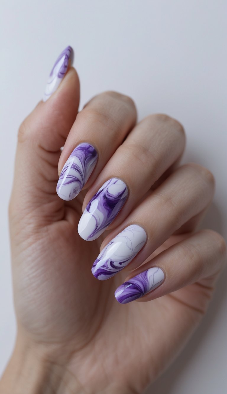 Hand angled slightly forward to show long nails in a marble nail art idea with dramatic violet and white swirl designs on a high-shine surface