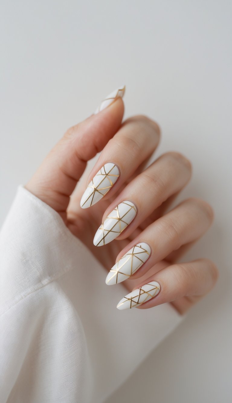 Feminine hand with long white nails featuring soft gold linear geometric accents, offering a graceful interpretation of a geometric nail art idea.