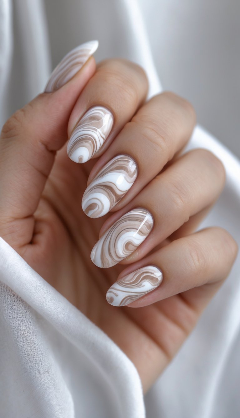 Hand with elegant beige and white swirl nail art idea, creating a flowing, wave-like pattern on long oval nails, resembling soft coffee art.