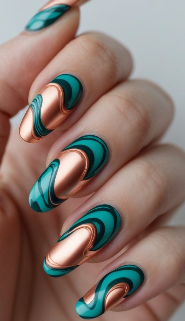 A hand with swirl nail art idea combining rose gold metallic swirls and dark green marbled curves for a bold, luxurious look.