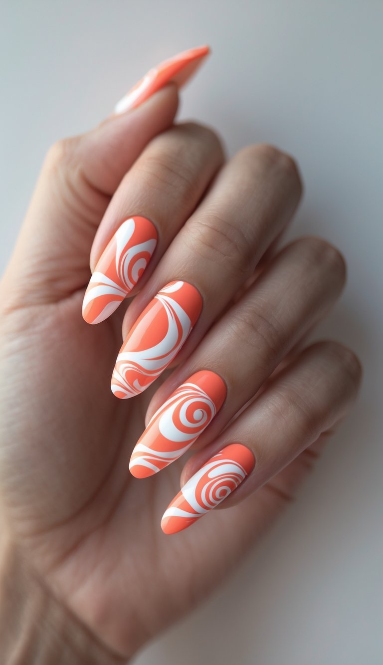 A playful swirl nail art idea featuring a hand with glossy orange nails and white swirl designs in circular and wave-like patterns.