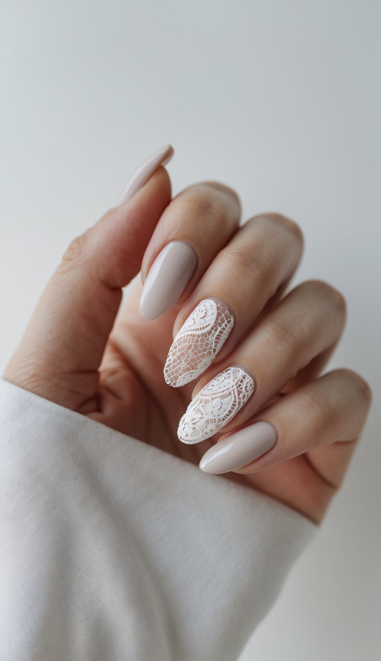 A hand with almond-shaped nails in a taupe base, featuring a lace nail art idea with intricate white lace detailing on the middle and ring fingers.