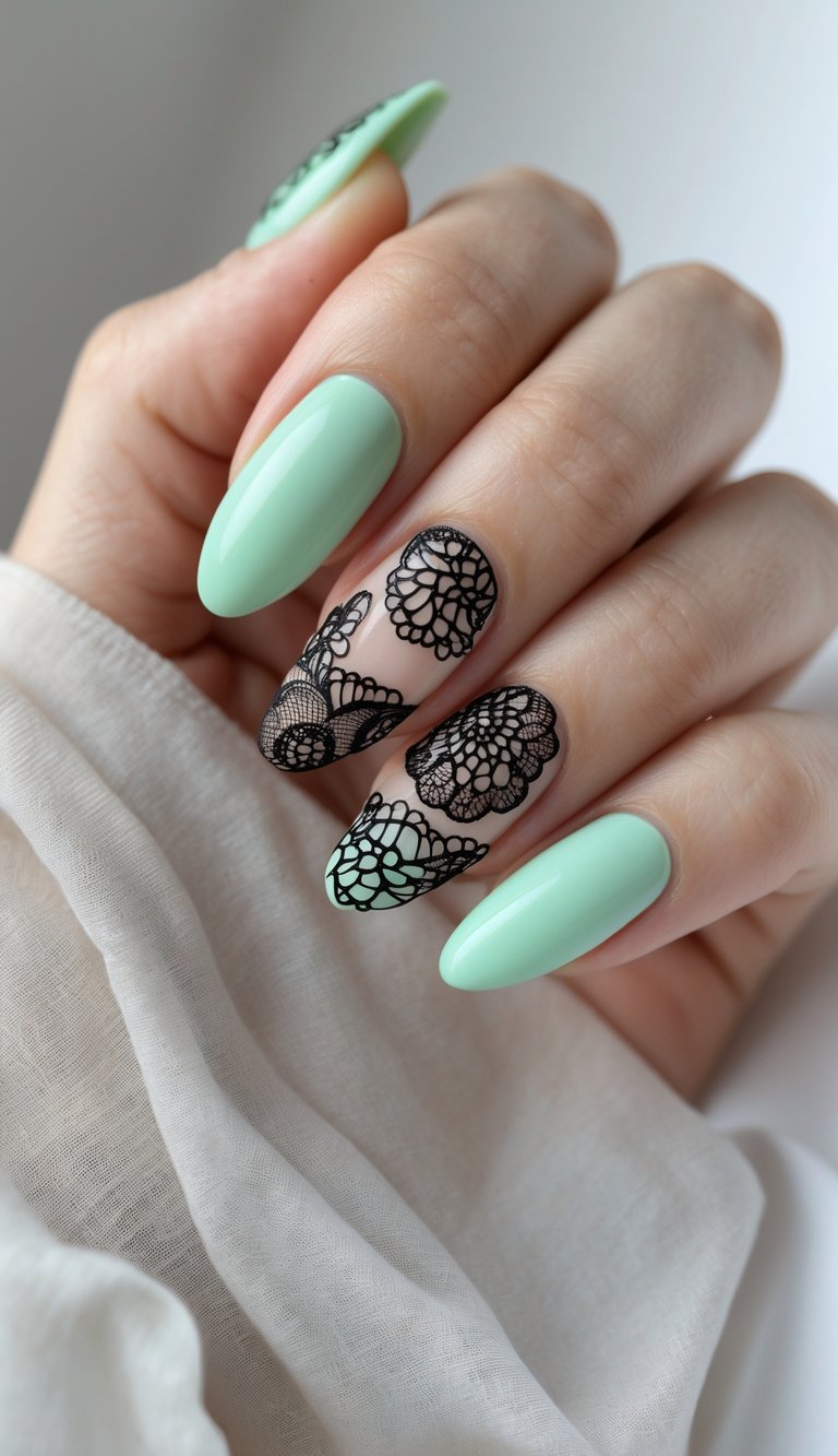 Almond-shaped nails in mint green with two feature nails showing a lace nail art idea using sheer polish and intricate black lace designs.