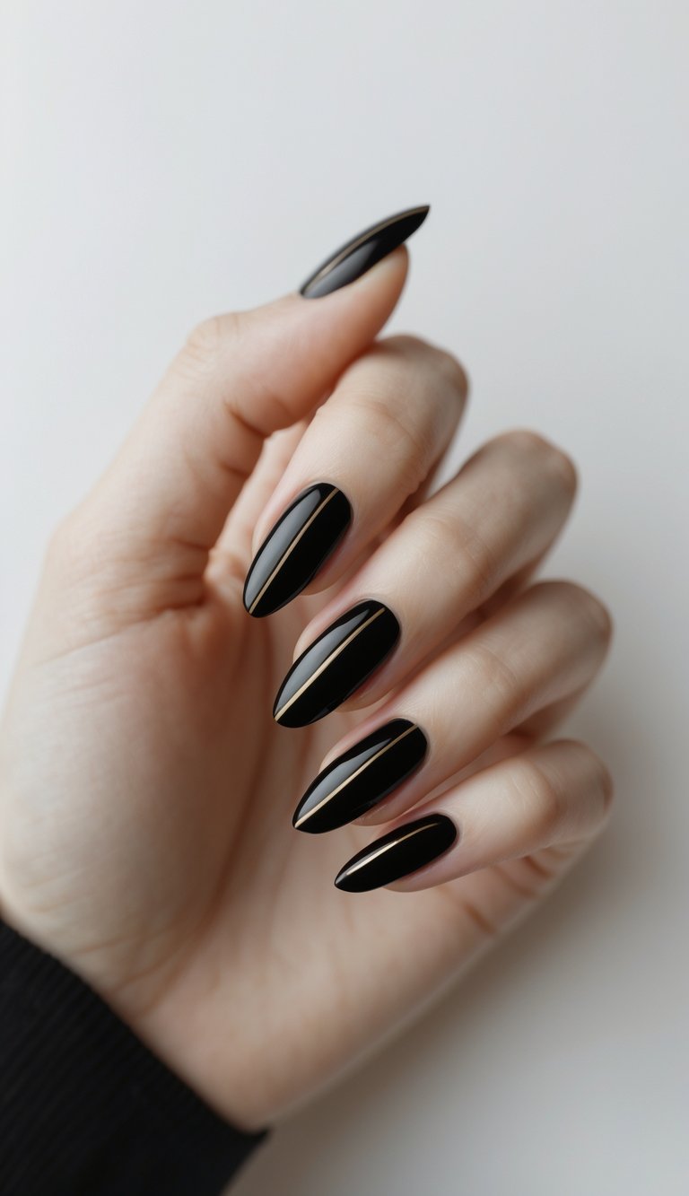 Close-up of hand featuring oval nail art idea with deep black polish and clean gold line detailing down the middle of each nail.
