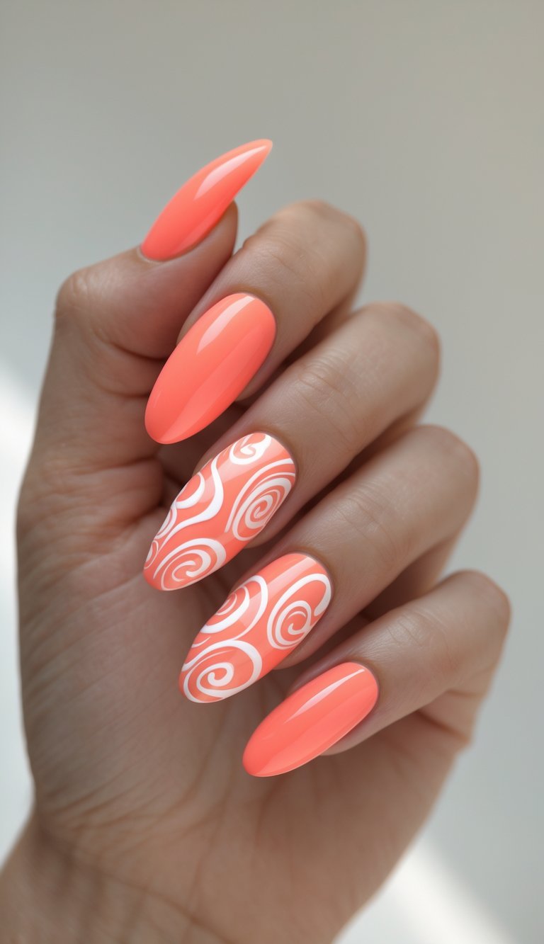 Hand showcasing oval nail art idea with vibrant tangerine orange base and two nails detailed in white modern swirl patterns.